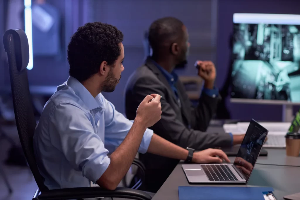 Cybersecurity professionals reviewing systems to demonstrate how to select a penetration testing provider.