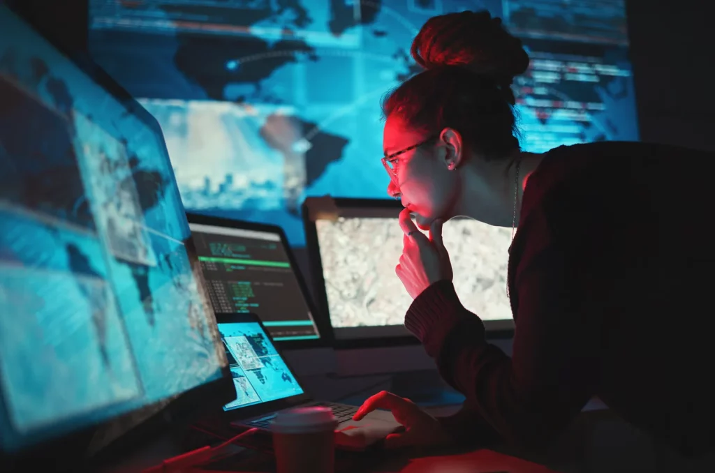 Cyber security analyst monitoring systems during a cyber incident response investigation to identify and contain threats.