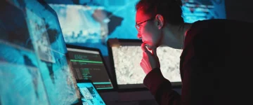 Cyber security analyst monitoring systems during a cyber incident response investigation to identify and contain threats.
